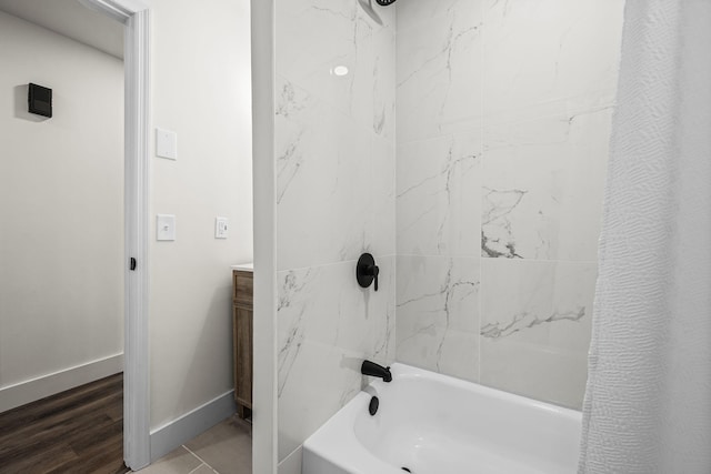 bathroom with hardwood / wood-style floors, shower / bath combo, and vanity