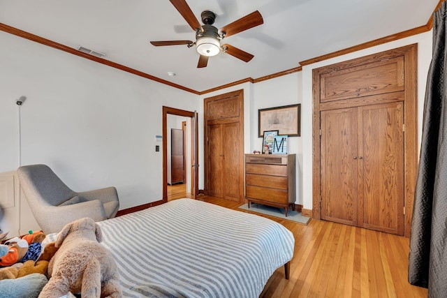 bedroom with ceiling fan, light wood-type flooring, and ornamental molding