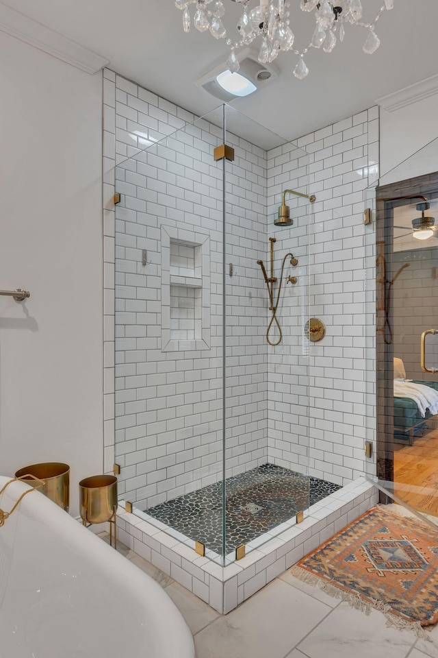 bathroom featuring crown molding and a shower with shower door