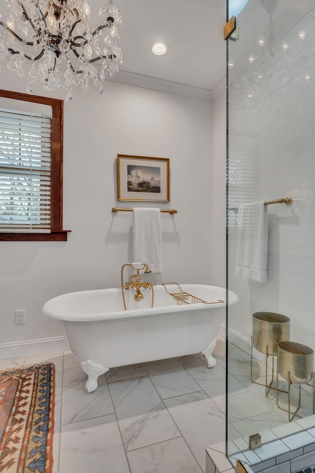 bathroom featuring a bath, an inviting chandelier, and crown molding