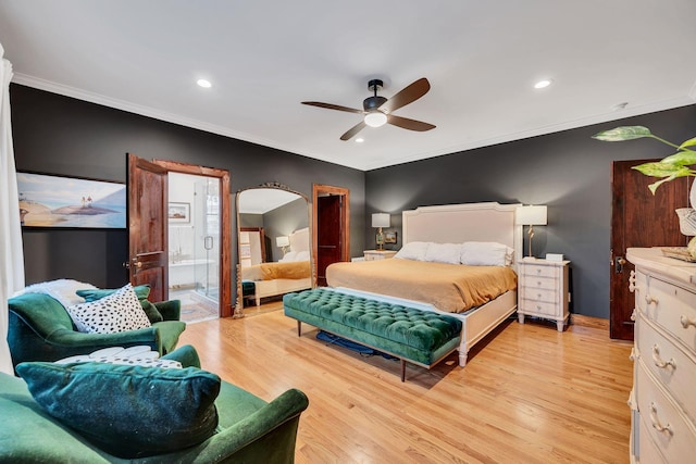 bedroom with ceiling fan, light wood-type flooring, crown molding, and connected bathroom