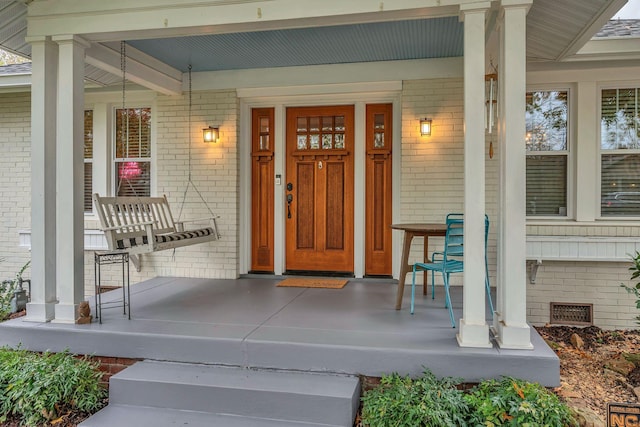 entrance to property featuring covered porch