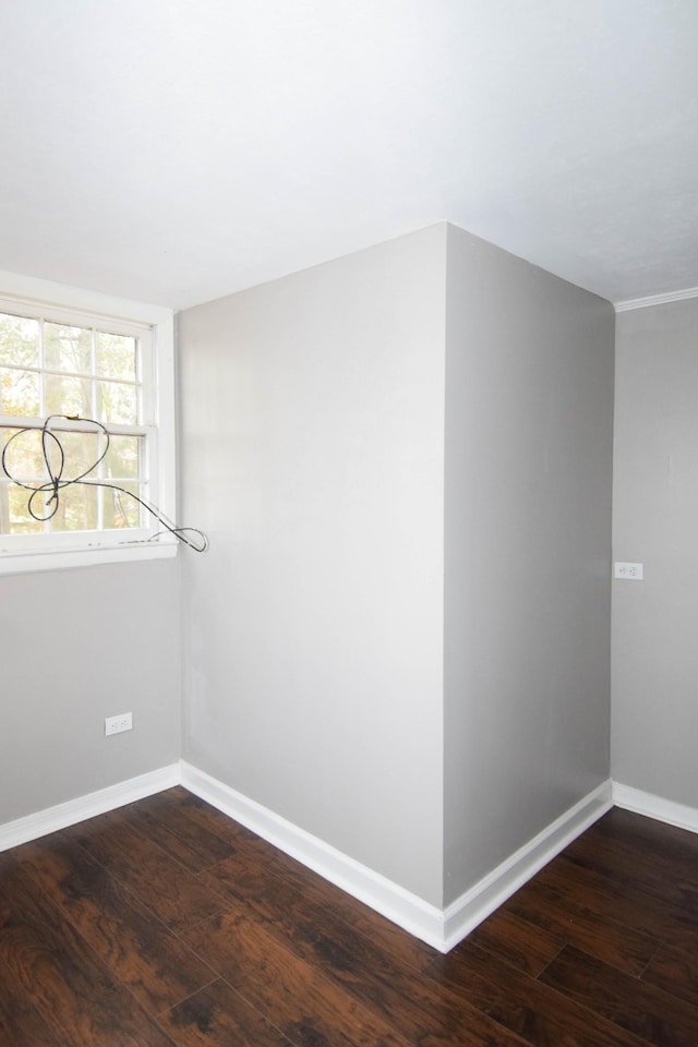 empty room with dark hardwood / wood-style flooring