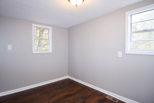 unfurnished room featuring dark wood-type flooring