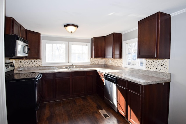 kitchen featuring a healthy amount of sunlight, crown molding, stainless steel appliances, and dark hardwood / wood-style floors