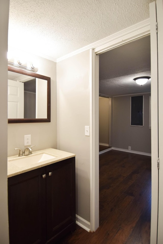 bathroom with hardwood / wood-style floors, vanity, and a textured ceiling