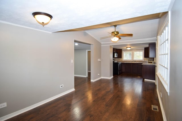 unfurnished living room with sink, vaulted ceiling, dark hardwood / wood-style floors, ceiling fan, and ornamental molding