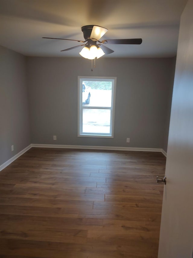 empty room featuring dark wood-type flooring and ceiling fan