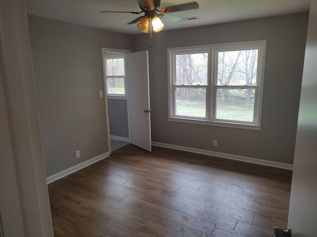 unfurnished room featuring dark hardwood / wood-style flooring and ceiling fan