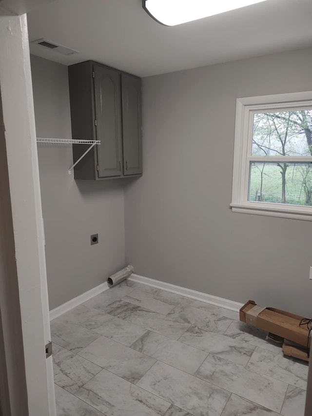 washroom with cabinets and hookup for an electric dryer