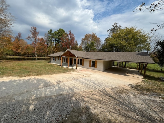 ranch-style home with covered porch and a front yard