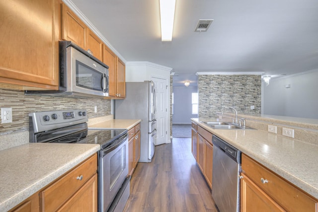 kitchen featuring sink, stainless steel appliances, dark hardwood / wood-style floors, crown molding, and decorative backsplash