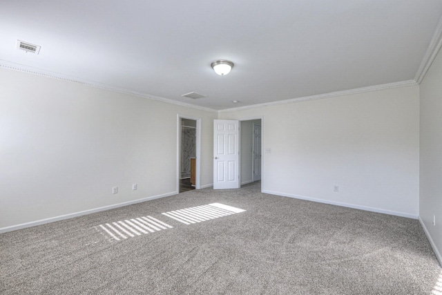 carpeted spare room featuring crown molding