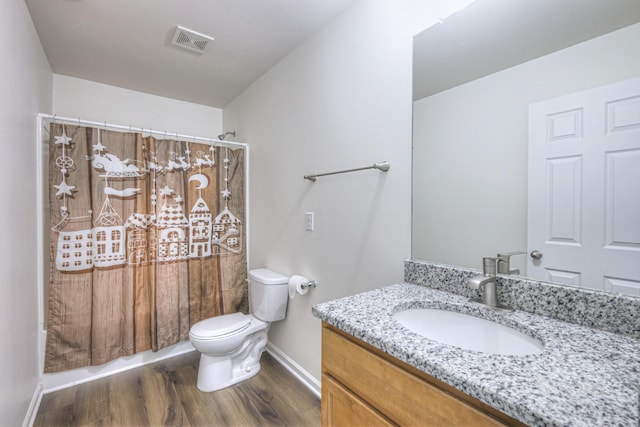 full bathroom with shower / bath combo, vanity, hardwood / wood-style flooring, and toilet