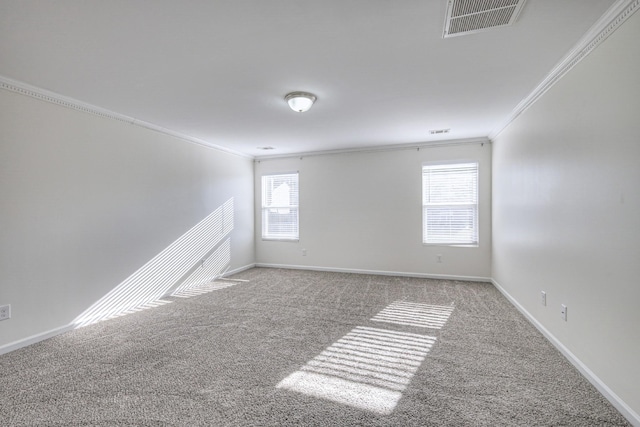 empty room with crown molding, a healthy amount of sunlight, and light carpet