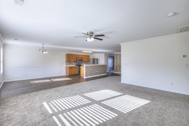 unfurnished living room with dark hardwood / wood-style floors, ornamental molding, and ceiling fan with notable chandelier