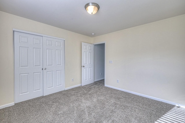 unfurnished bedroom featuring carpet floors and a closet