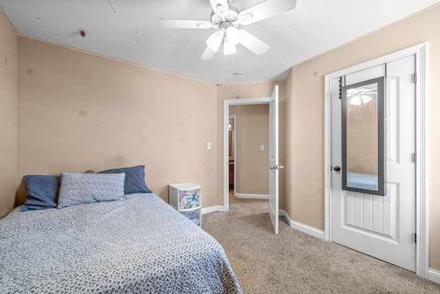 bedroom with ceiling fan, light colored carpet, and a closet