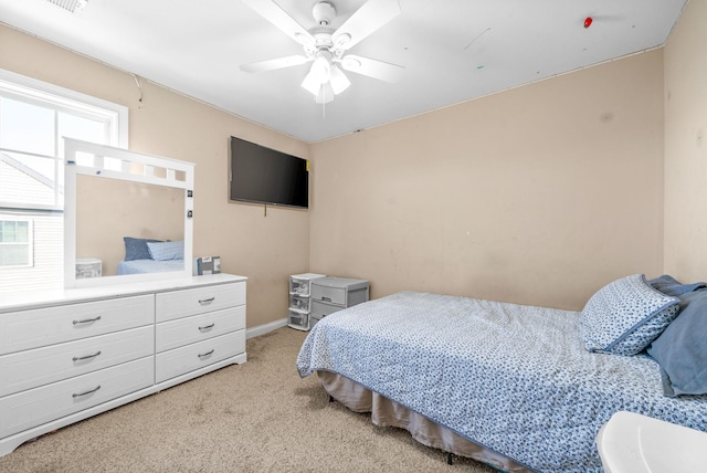 bedroom featuring light colored carpet and ceiling fan