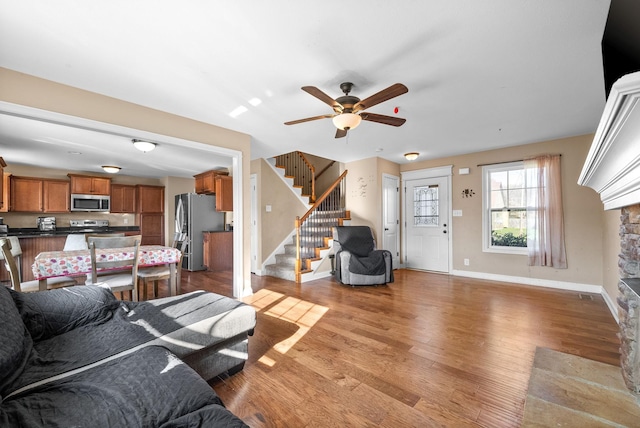 living room featuring ceiling fan and hardwood / wood-style floors