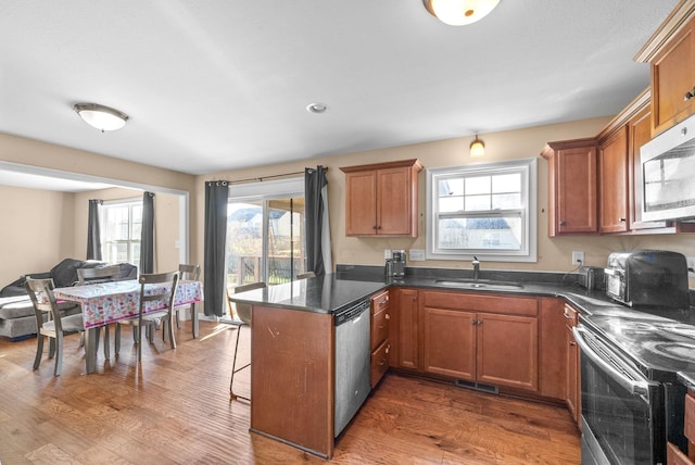 kitchen featuring dark hardwood / wood-style floors, a healthy amount of sunlight, and appliances with stainless steel finishes