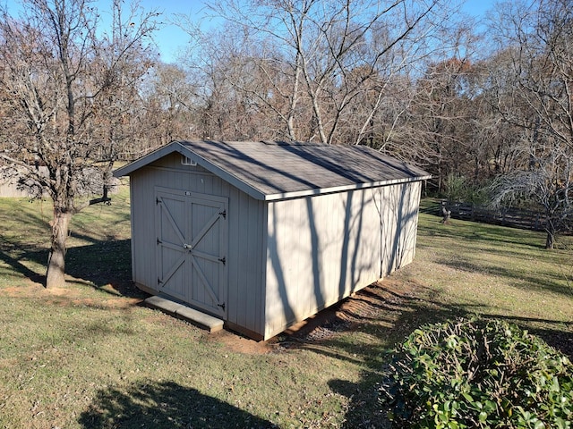 view of outdoor structure featuring a lawn