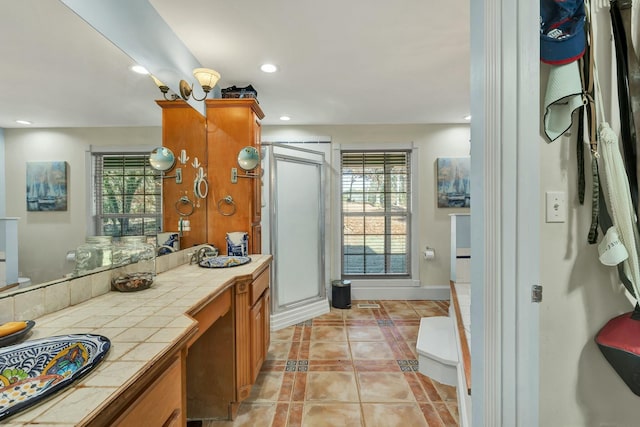 bathroom with tile patterned flooring, vanity, and a shower with shower door