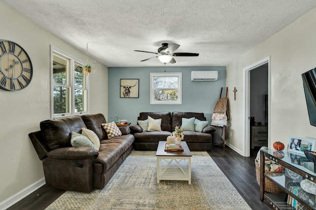 living room featuring a textured ceiling, a wall mounted AC, ceiling fan, and dark hardwood / wood-style floors