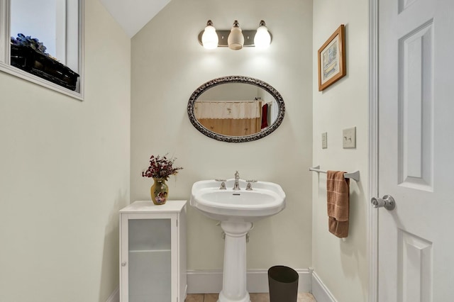 bathroom with tile patterned flooring and lofted ceiling