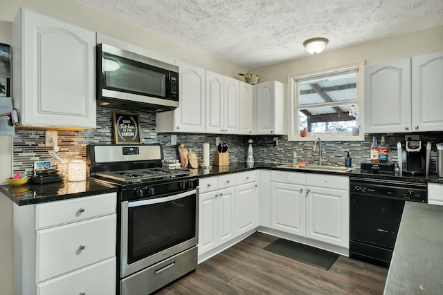 kitchen with stainless steel appliances, white cabinetry, dark wood-type flooring, and sink