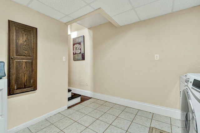 interior space with light tile patterned floors and washer and dryer