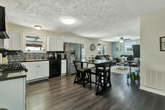 kitchen with dishwasher, dark wood-type flooring, stainless steel refrigerator with ice dispenser, ceiling fan, and white cabinetry