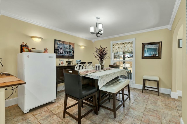 dining space featuring a chandelier and ornamental molding