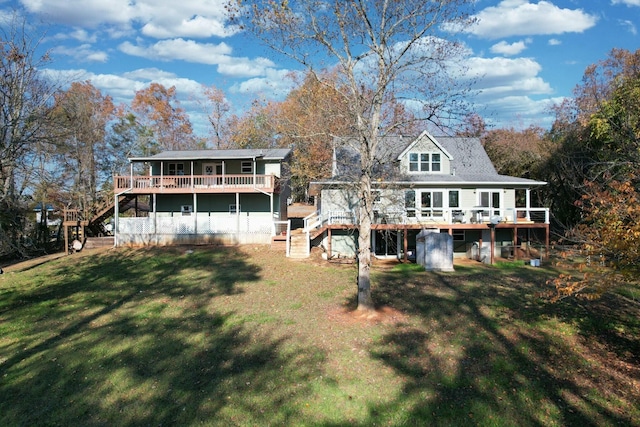 rear view of property with a yard and a deck