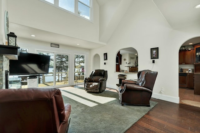 living room with dark hardwood / wood-style floors and high vaulted ceiling