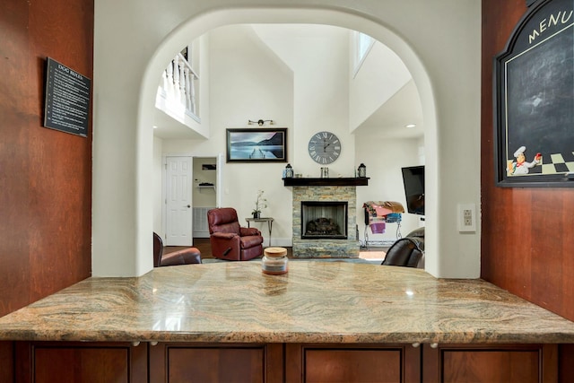 kitchen with light stone countertops and a fireplace