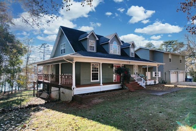 view of front of property featuring a front yard, a porch, and a garage