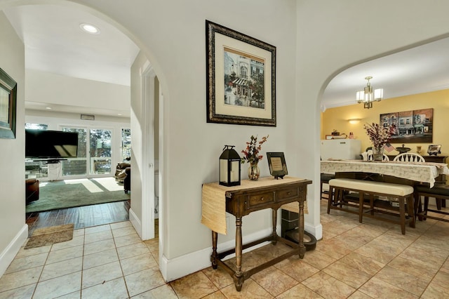 hallway with an inviting chandelier