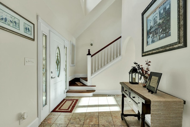 tiled entrance foyer with lofted ceiling