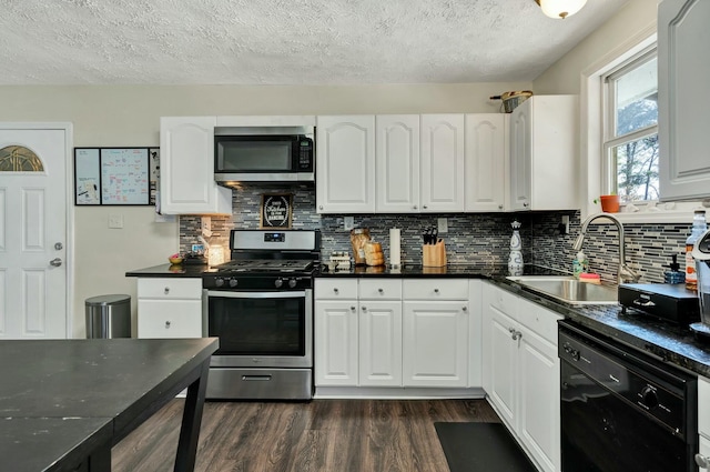 kitchen with white cabinets, dark hardwood / wood-style flooring, sink, and stainless steel appliances