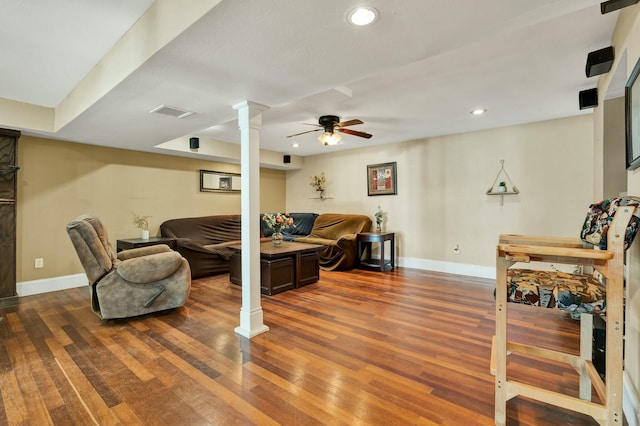 living room featuring ceiling fan and dark hardwood / wood-style floors