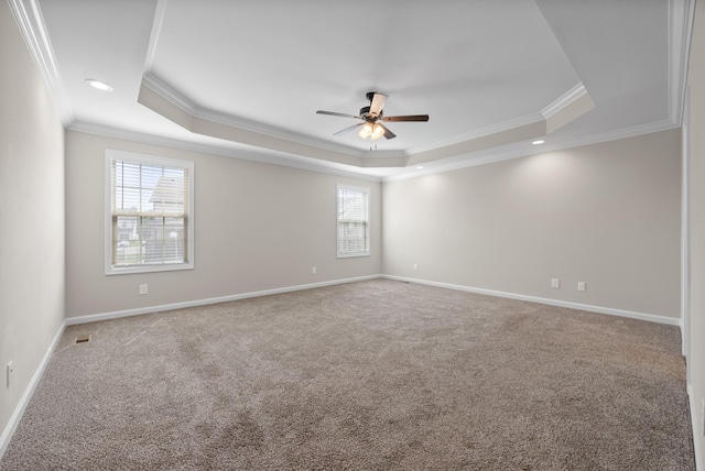 unfurnished room with ceiling fan, a raised ceiling, and ornamental molding