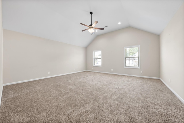 carpeted spare room with vaulted ceiling and ceiling fan