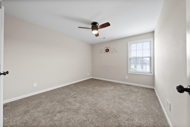 empty room featuring carpet flooring and ceiling fan