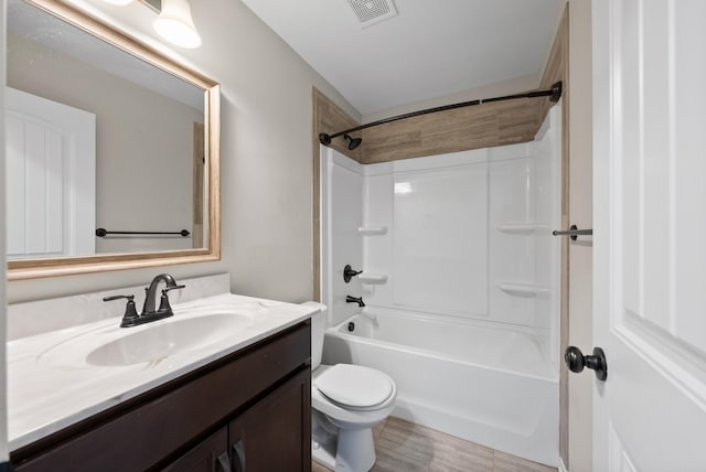 full bathroom featuring wood-type flooring, vanity, bathing tub / shower combination, and toilet