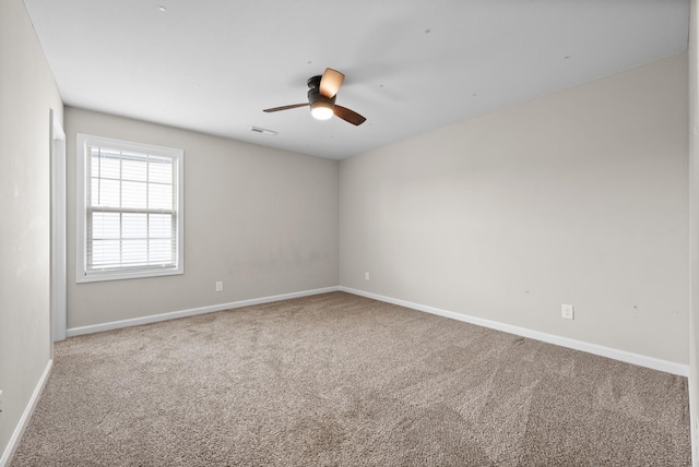 carpeted empty room featuring ceiling fan