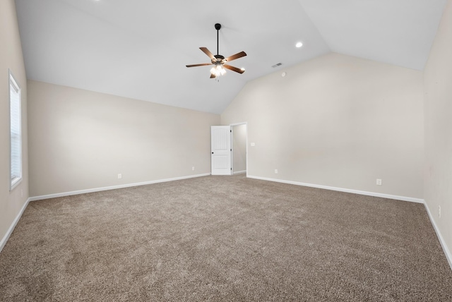 empty room with ceiling fan, carpet, and lofted ceiling