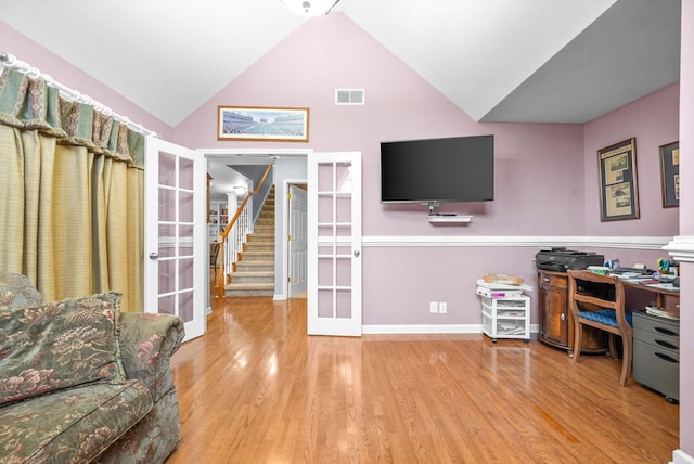 office space featuring french doors, high vaulted ceiling, and wood-type flooring