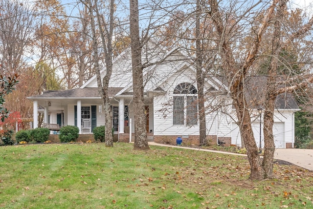 view of front of house with a porch, a garage, and a front lawn