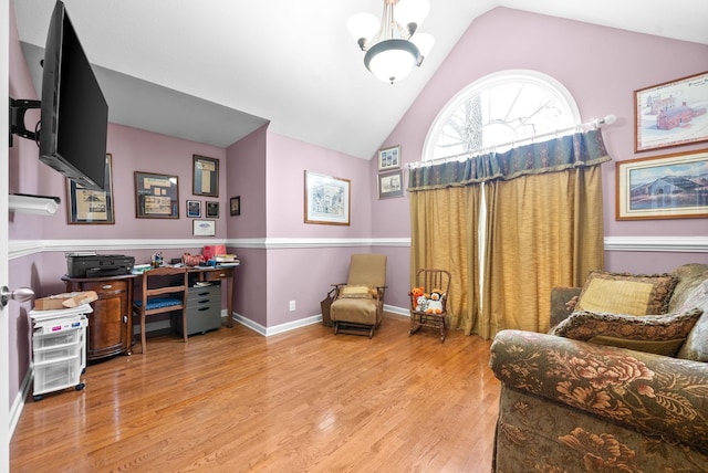 sitting room featuring light hardwood / wood-style floors, an inviting chandelier, and vaulted ceiling